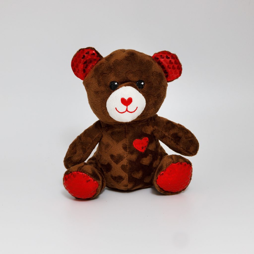 Cute plush teddy bear with heart decorations, perfect for Valentine's Day gifts or decoration.